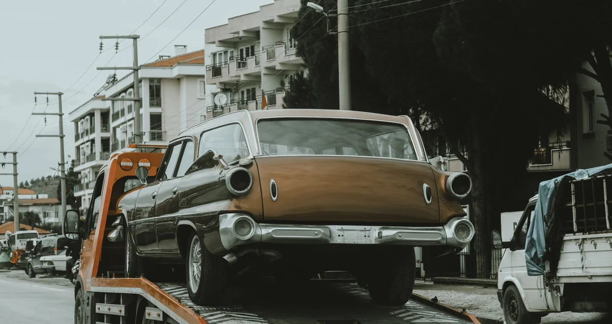 A car loaded on a flatbed truck for vehicle transport